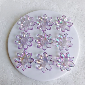 Macro view of purple AB aurora acrylic flower pendants with nine pieces on a white tray