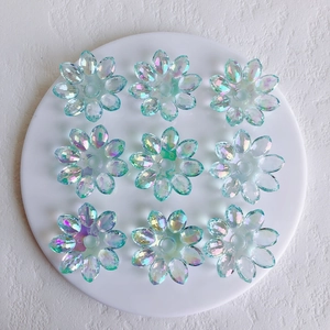 Macro shot of 9 colorful aurora acrylic flower charms for DIY jewelry making