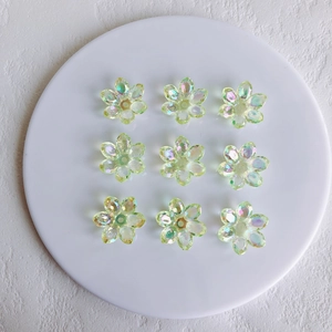 Detailed view of iridescent aurora acrylic flower charms for DIY jewelry making