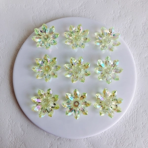 Detail of aurora acrylic flower charms for jewelry making with iridescent finish