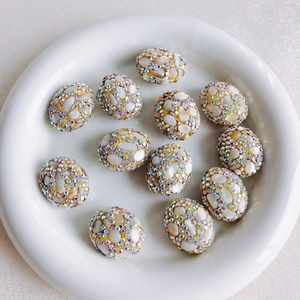 Detailed view of 12pcs yellow floral oval beads with white stones and rhinestones for DIY