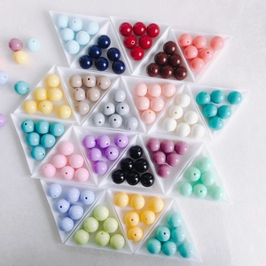 Close-up of colorful acrylic round beads in triangle trays for DIY jewelry making