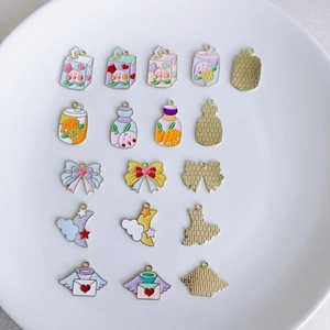 Close-up of pastel enamel alloy charms in butterfly and star shapes for DIY jewelry making