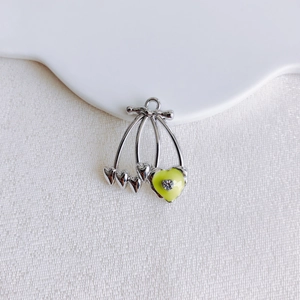 Detailed view of heart-shaped cherry pendant with green enamel and crystal for DIY jewelry