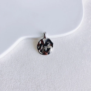 Macro view of silver vintage coin pendant with irregular hammer texture for DIY jewelry