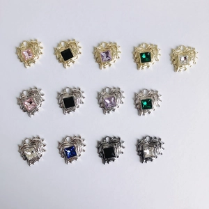 Detailed view of heart-shaped pendants with lava texture and colorful cubic zirconia stones