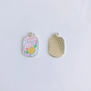 Detail of purple cartoon drink alloy pendant showing front enamel and gold textured back