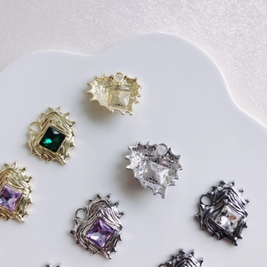 Irregular heart pendants with colorful zircon in gold and silver plating on white display
