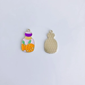 Detail of fruit jam jar enamel pendant for DIY jewelry making with gold plated metal finish