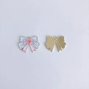 Close-up of colorful enamel bow charms with gold plating for DIY jewelry making