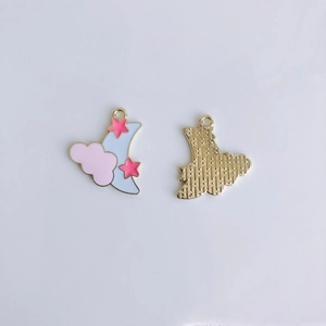 Detail of alloy cartoon moon and star pendant showing front colorful oil drip and back texture