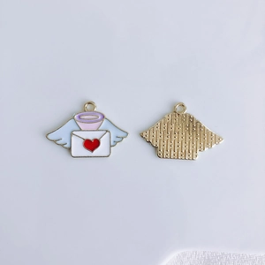 Detail showing front and back of winged heart envelope charms for DIY jewelry making