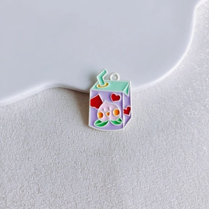 Close-up of a purple milk box alloy pendant with a peach icon and heart for DIY crafts