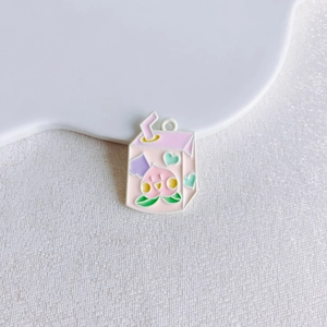 Cute pink milk carton charm with peach illustration and hanging loop for DIY jewelry