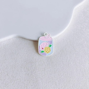Macro detail of enamel beverage charms with lemon patterns for DIY jewelry making