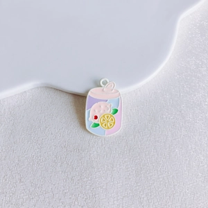 Detailed view of pink pig and lemon charm pendant in a beverage jar design