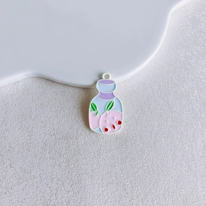 Detail of macaron-colored alloy bottle charms with fruit patterns for DIY jewelry making