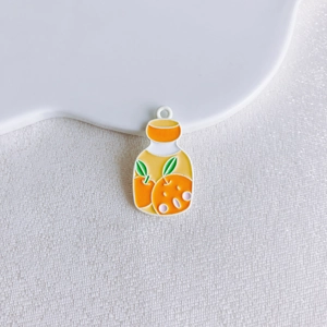 Macro shot of an orange fruit bottle alloy pendant with smooth enamel finish and top ring