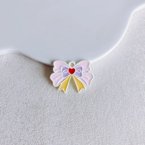 Close-up of a colorful enamel alloy butterfly pendant with a red heart for DIY jewelry