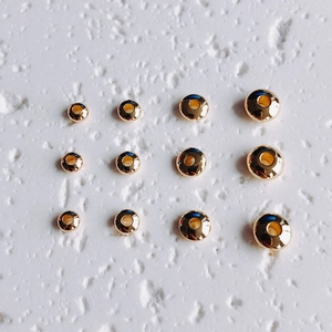 Detail of 14K gold filled round spacer beads in four sizes for DIY jewelry making