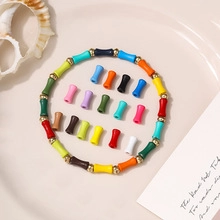 Flat lay of bohemian colorful acrylic tube beads and handmade DIY bracelet materials