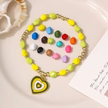Macro shot of colorful faceted beads and heart pendants for DIY jewelry making projects