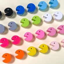 Macro view of colorful Pac-Man shaped silicone accessories for DIY jewelry making