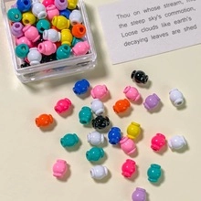 Close-up of colorful pumpkin-shaped alloy beads for DIY jewelry and necklace crafting