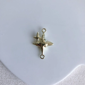 Detailed view of golden star connector charms for DIY necklace and jewelry making
