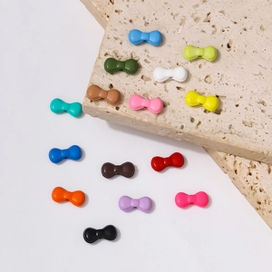 Kleurrijke strik kralen set van hars voor DIY sieraden maken op witte achtergrond steen