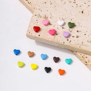 Detailed view of colorful heart-shaped alloy beads for DIY jewelry making and crafts