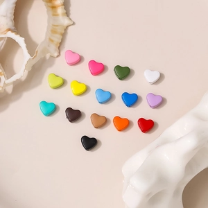 Macro detail of colorful heart-shaped beads for DIY jewelry making with side hole
