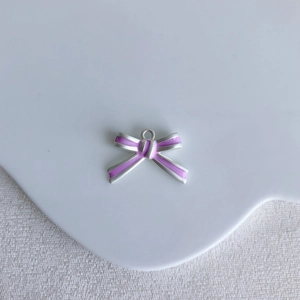Detailed view of pink bow alloy pendant charm with silver edges for DIY jewelry making