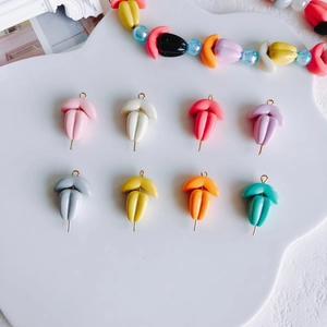Macro shot of colorful tulip resin pendants with gold rings for DIY jewelry making