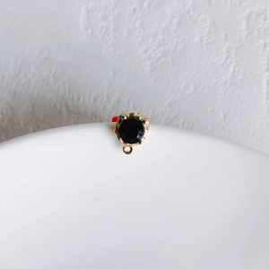 Detail showing vintage black faceted gemstone pendant with golden lava texture metal base