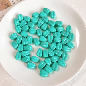 Close-up of tiffany blue acrylic wheat ear beads for DIY jewelry making and crafts