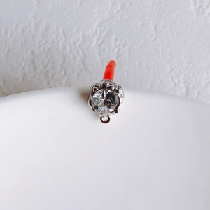 Macro shot of silver round rhinestone pendant with high-quality cubic zirconia detail
