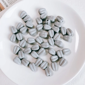 Macro detail of glossy grey sunflower seed beads for DIY jewelry and phone chain accessories