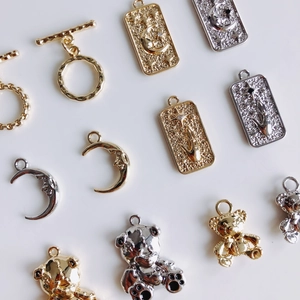 Golden and silver mini OT buckles with moon bear pendants for DIY jewelry making