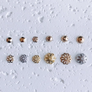 Macro detail of various 18K gold and silver plated flower bead caps for DIY jewelry