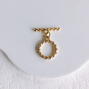 Detailed close-up of golden OT toggle clasp with twisted texture for DIY jewelry making