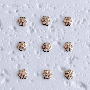 Macro shot of 18K gold-plated flower bead caps for DIY jewelry necklace making