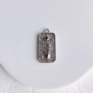 Detailed view of rectangular silver pendant with embossed palm and black crystal star