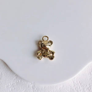 Golden 3D mini bear pendant charm accessory for handmade jewelry with smooth metallic finish