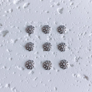 Set of 9 silver floral spacer beads with hollow six-petal design for DIY jewelry making