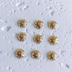 Detailed view of nine 18K gold-plated hollow petal bead caps for DIY jewelry making