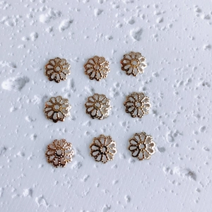 Detailed view of 18K gold hollow flower spacers for DIY jewelry making and beading projects