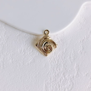 Detail of square gold-plated sun coin pendant with floral relief for DIY jewelry