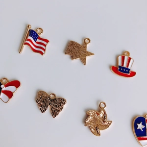 Macro detail of alloy USA flag charms with red white and blue enamel and gold finish