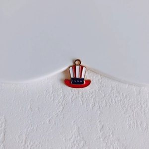 Macro shot of American Uncle Sam hat pendant with red white stripes and blue starry band